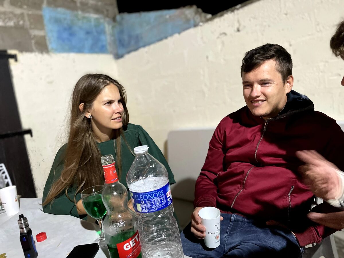 Pauline et Benjamin attablés un soir, un verre à la main